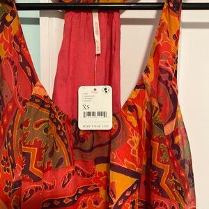 NWT Free People racer back flowy top  Strawberry tank. Easily fit a small